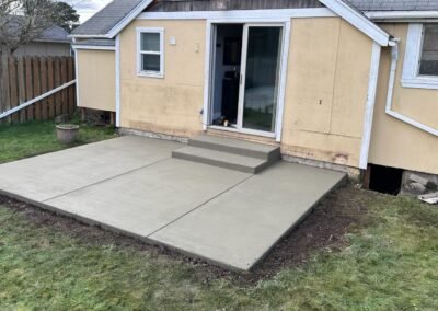 Newly installed concrete patio with smooth steps in a Portland home, showcasing a perfectly leveled surface.