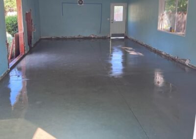 Glossy finish on newly laid indoor concrete flooring by JustFaith Concrete Contractors in Portland, illustrating a sleek and modern residential upgrade.